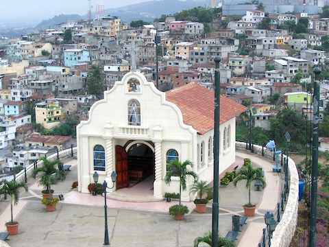 Looking down at the terrace where the small, tile-roofed,
      white church sits