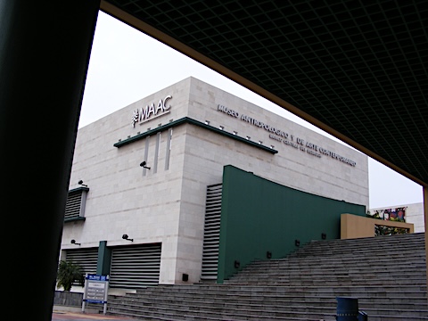 The museum is at the top of
         steps and is seen below an angled roof covering a food stand