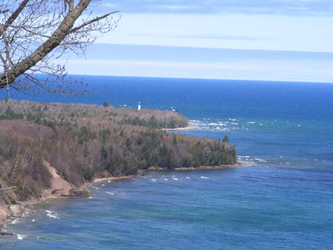 View from the Log Slide Overlook toward the Au Sable Light Station. 
          The sky and lake are deep blue but the wind is blowing up whitecaps