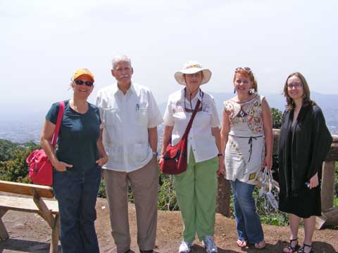 Scene shows the sightseers lined up in front of
                    the city far below