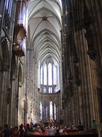 Looking toward the end of the cathedral from the center, 
           the interior appears narrow, flanked by vertical columns
           rising to the pointed arches of the ceiling high above.
           The sides appear dark while the ceiling and end are light.