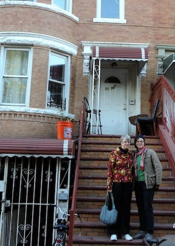 Gail and CJ standing on the steps to CJ's apartment