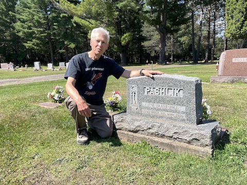 Al kneels on one knee to the left of the grey Pashlik stone.