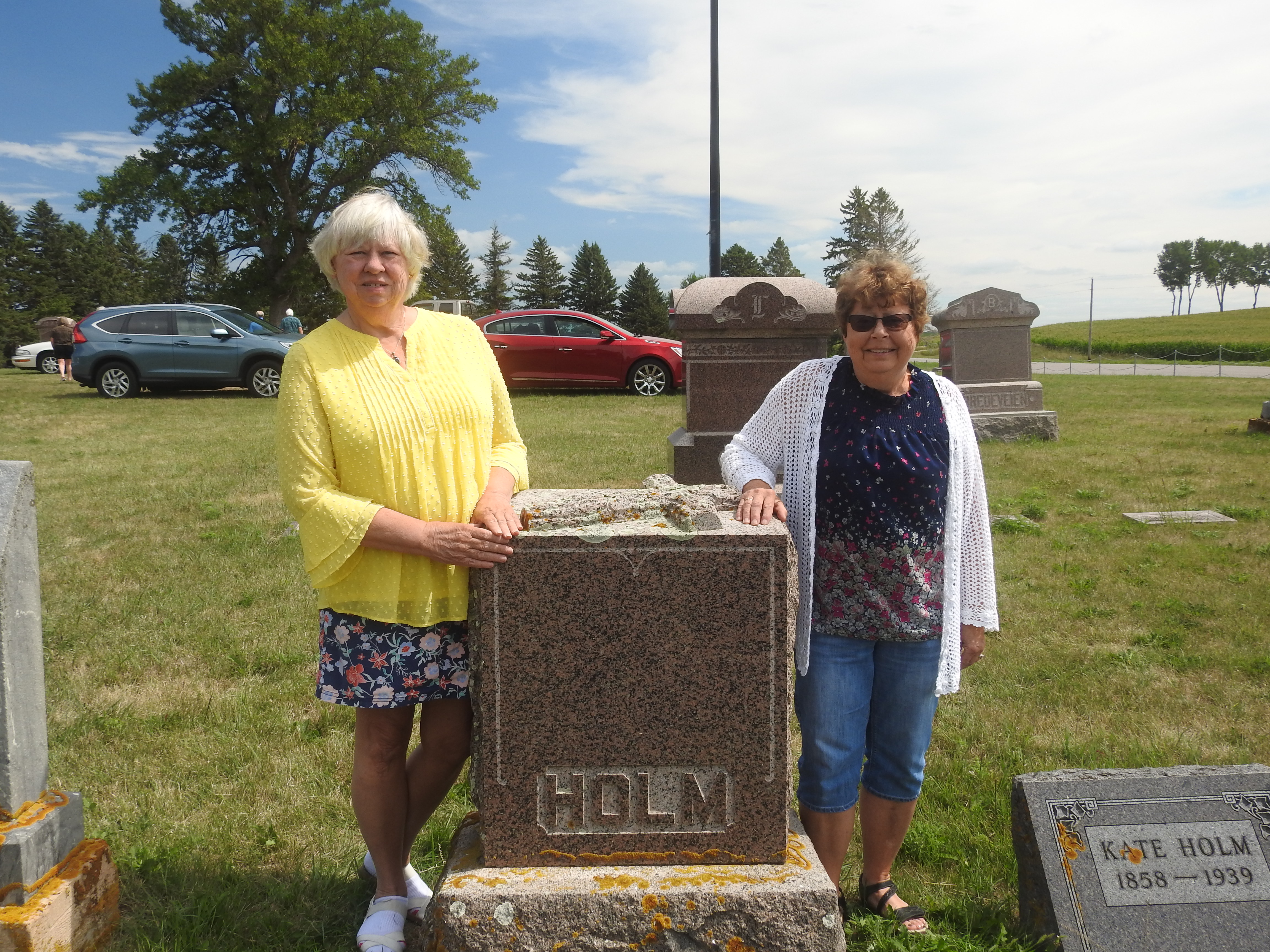 Eunice and Norma are standing alongside the Holm monument