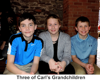 The three children are sitting on a bench at the Ore Dock Brewing Company 
           in Marquette, Michigan