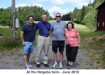 The cousins are standing with the farm field in the background.