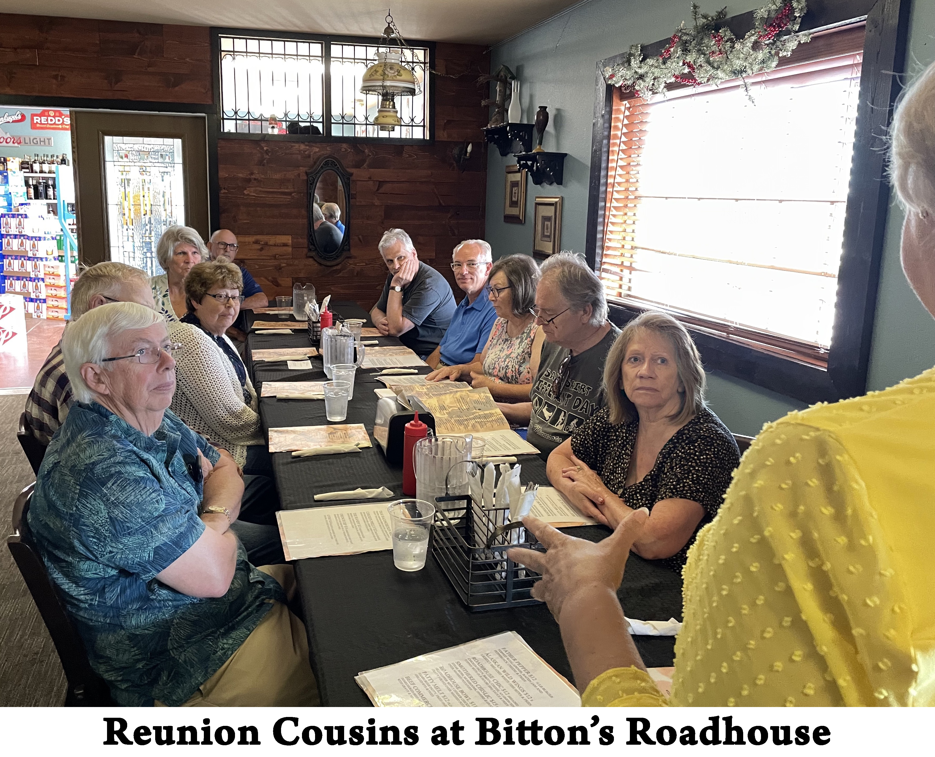 The long table has five people sitting on each side.  