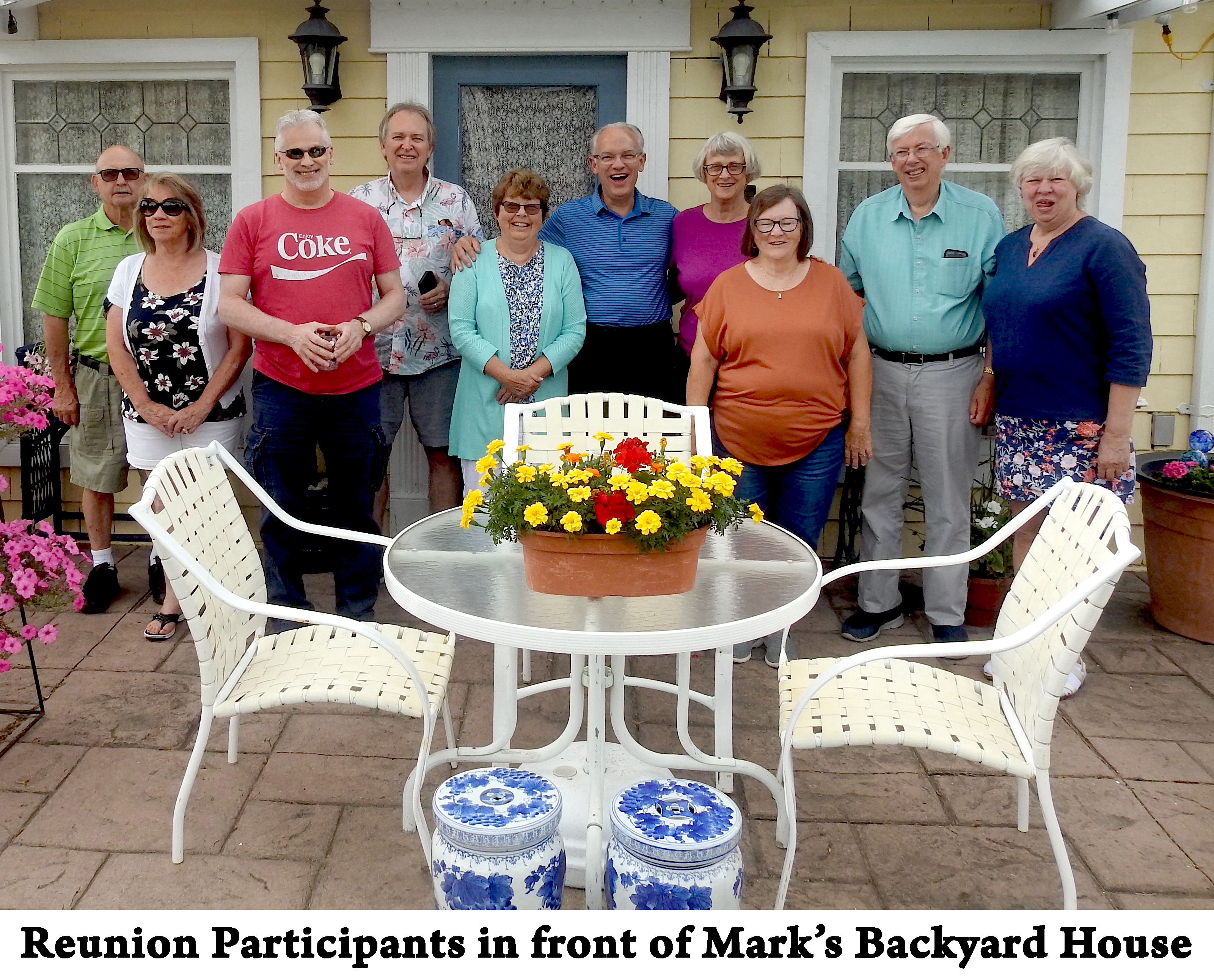 The group is standing in a row and looking at the camera 