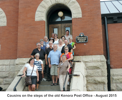 People statnding on the steps of Kenora's City Hall. On the 
             wall above them is a sign saying 'Provincial Offences Office'