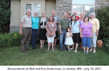 Cousins, spouses, and children standing in a line in front of Michael Holm’s home