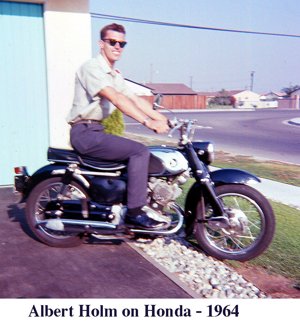 Albert Holm wearing dark sunglasses and sitting on his black Honda motorcycle