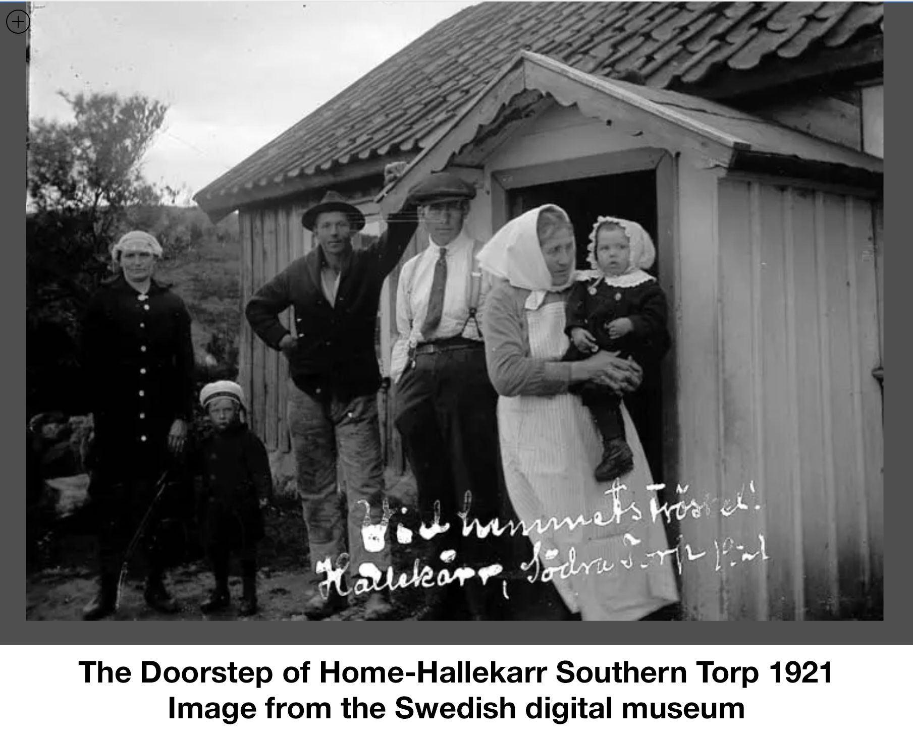 People pose at the entrance to the house