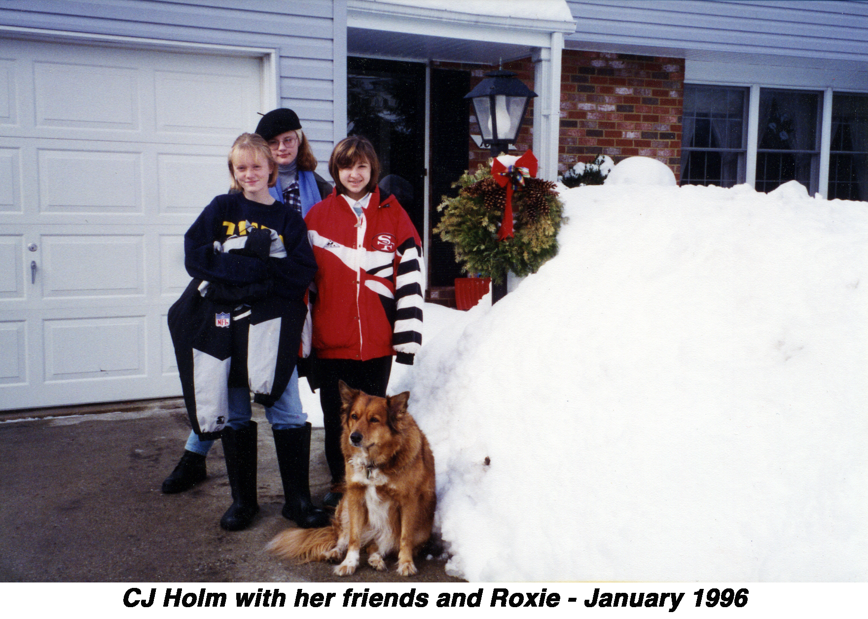 CJ, her friends, and Roxie are in our driveway next to a huge pile of snow