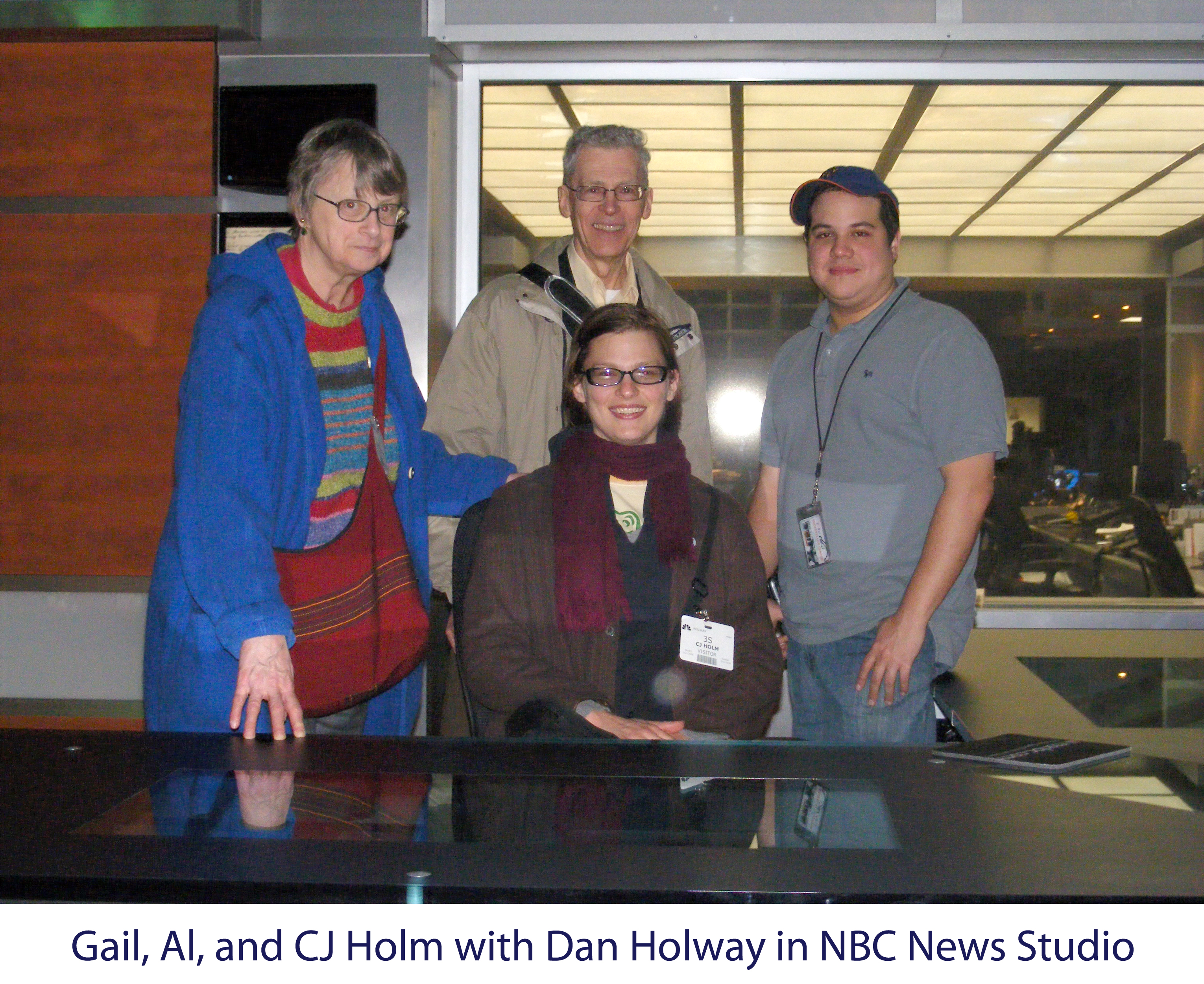 CJ is sitting at the anchor’s desk and the rest of us standing behind her.