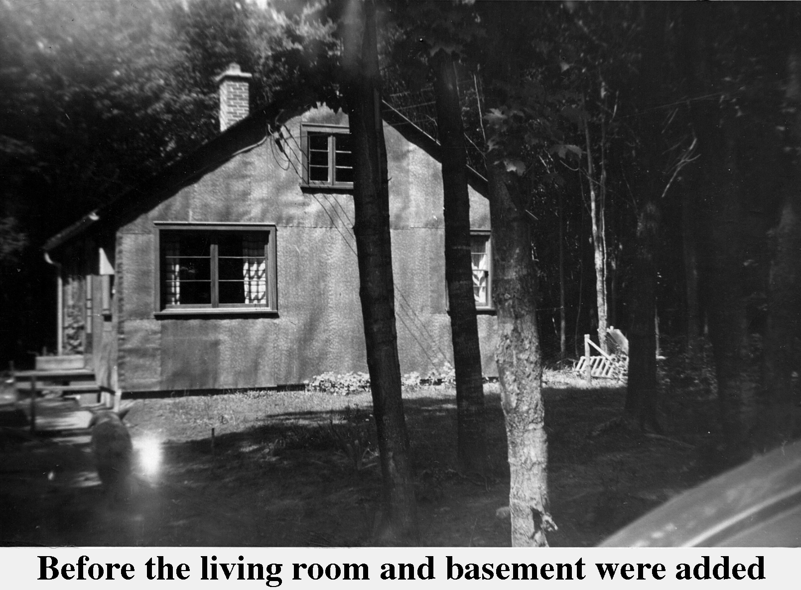 Our tar-paper covered house seen through the trees near 
       Passamani Road