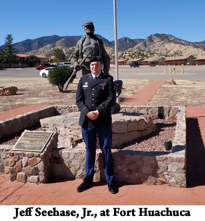Jeff, Jr., is in his dress uniform standing in front of the monument with 
     the mountains in the background 
