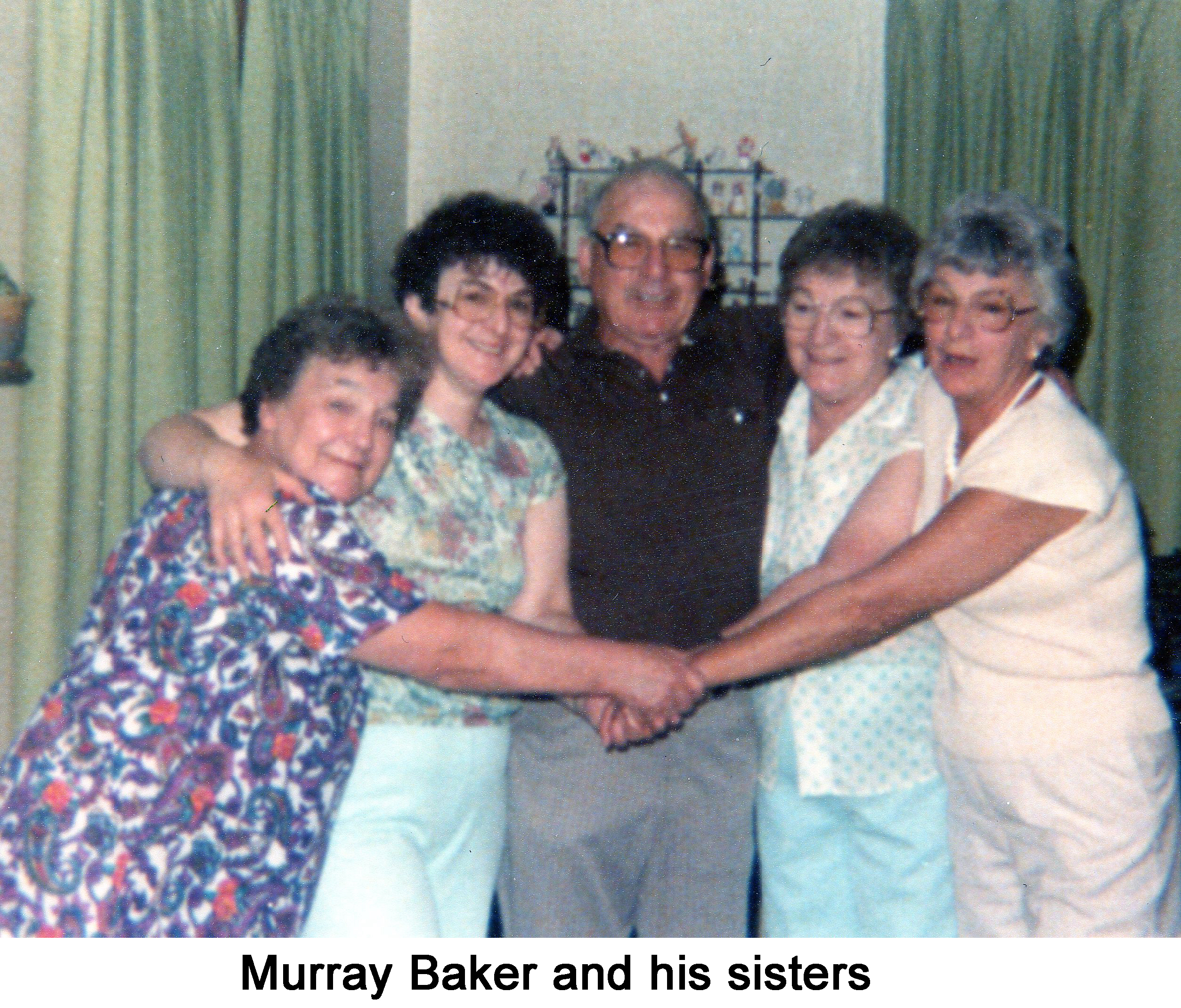 This photo was taken when the family was older. 
     Murray is standing in the middle with two sisters on either side. 
     The women are clasping hands.