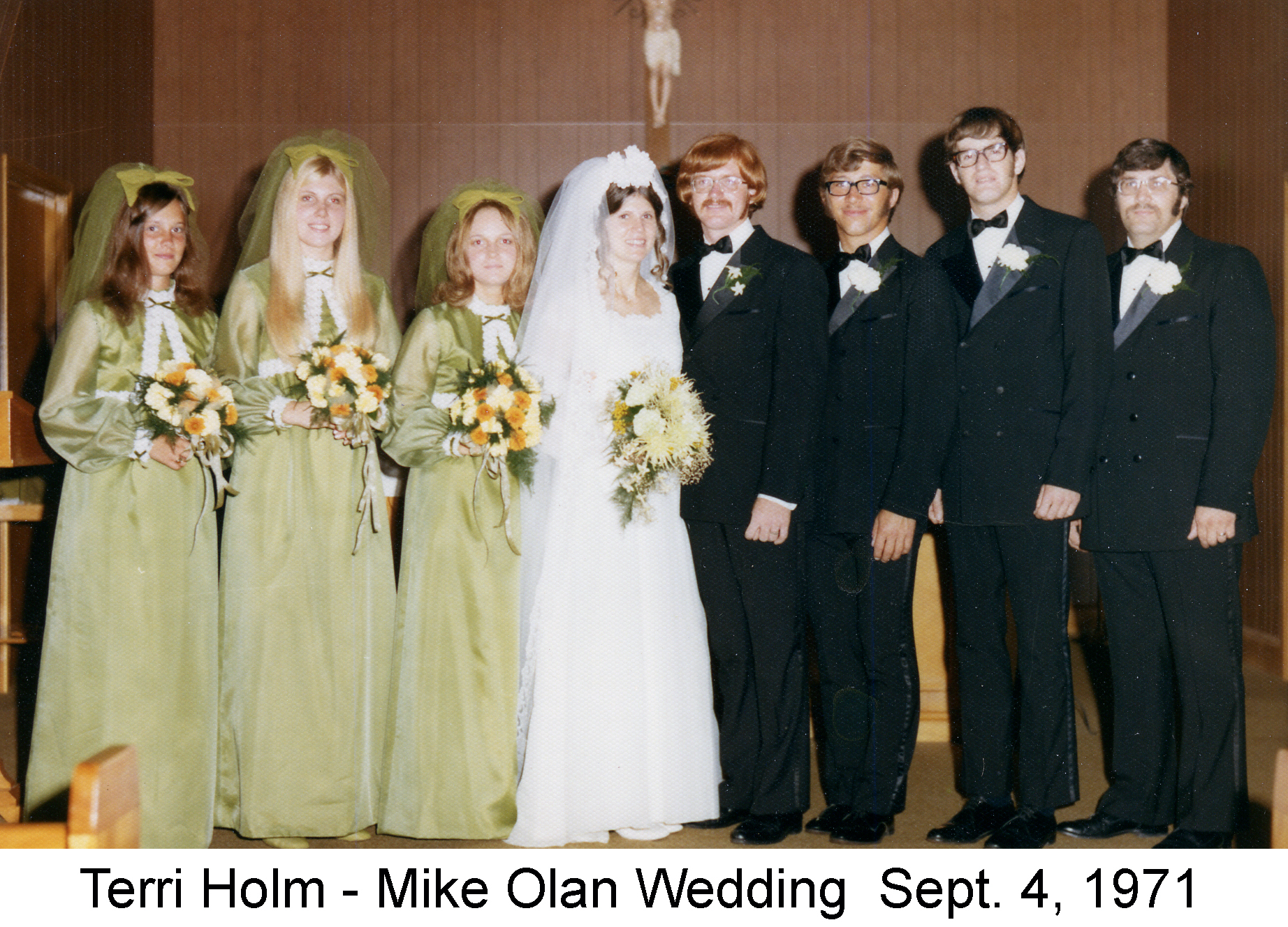 Terri Holm and Michael Olan at the altar with attendants on each side