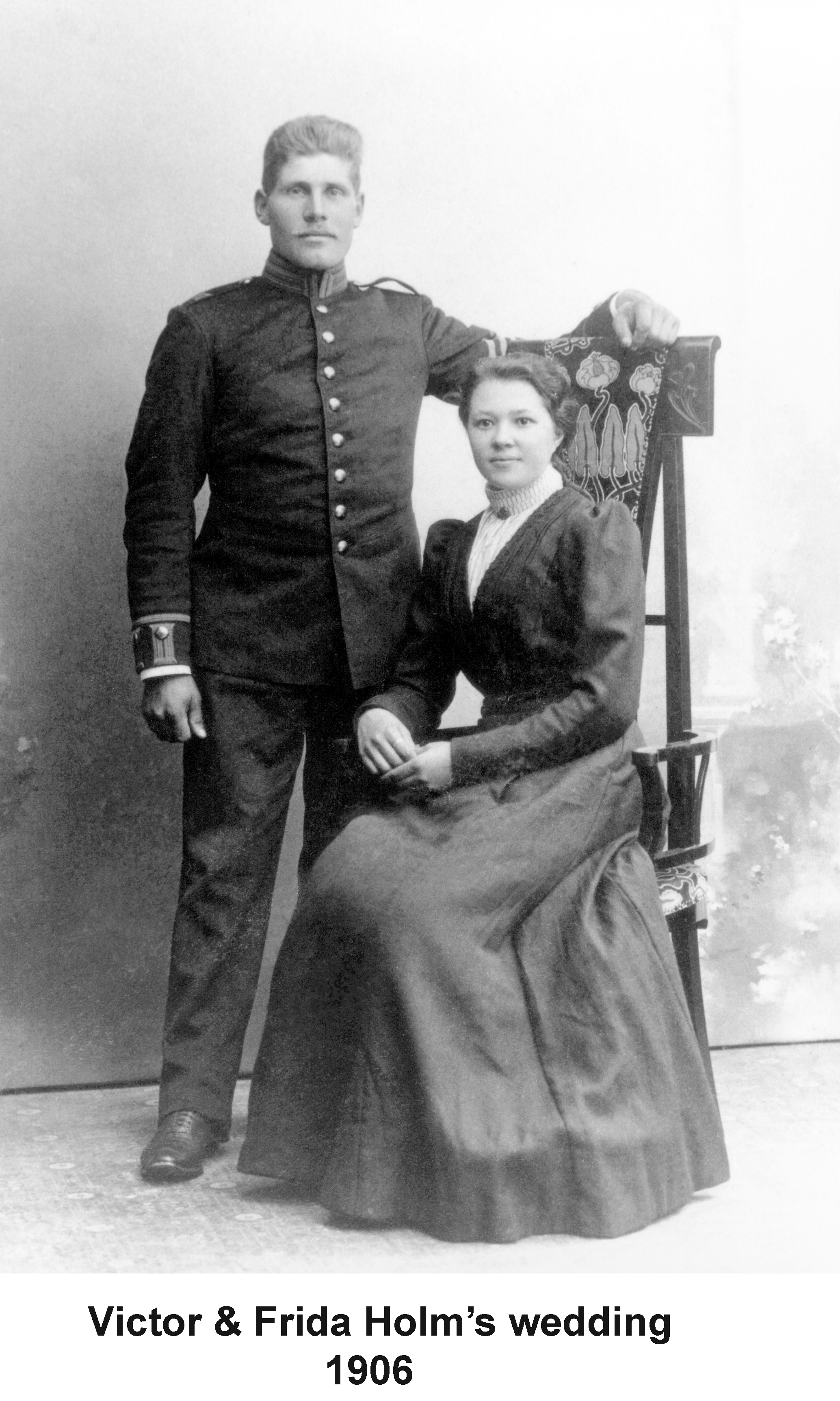 Victor Holm and Frida Sorquist on their wedding day, 1906. In this photo
       he is standing and she is seated.