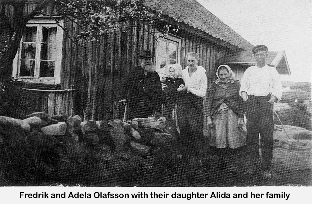 The family members are posing near a stone wall in front of a house