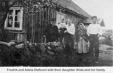 Family members posing near a stone wall in front of a house