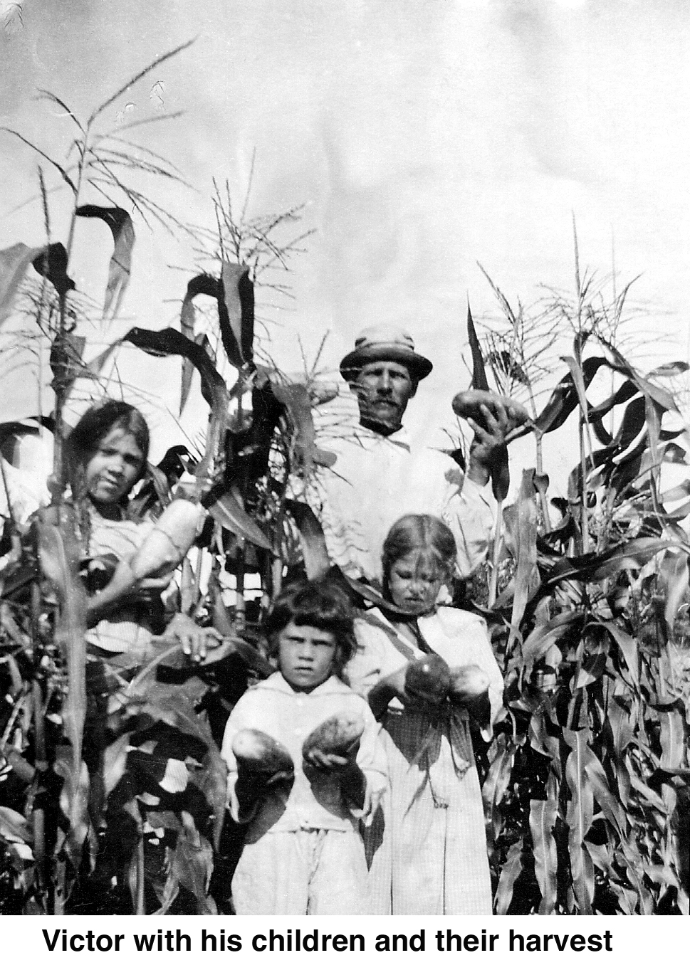 Victor and children with the harvest