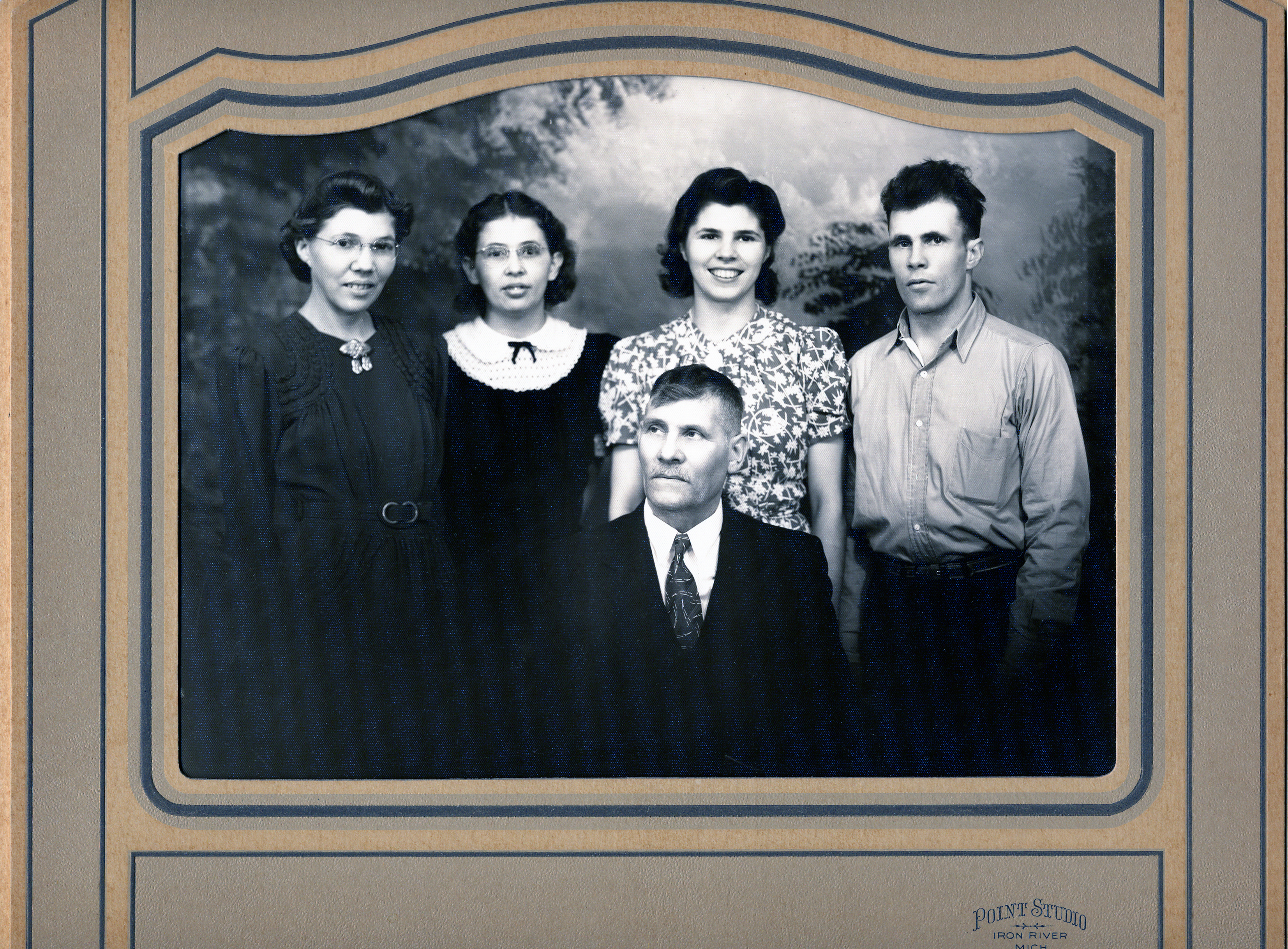Victor Holm and his children in a studio photograph