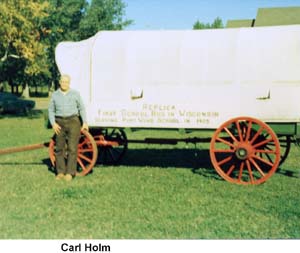 Carl Holm in front of a replica of the Port Wing school bus seen on page 12