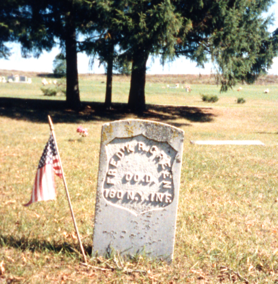 Fred Green's gravestone. A flag on a stick was placed next to it.