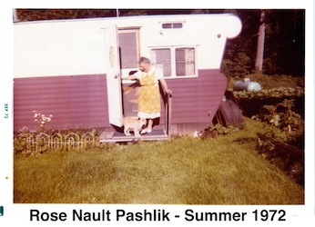 Rose Nault standing on the proch of her trailer with a tan cat at her feet