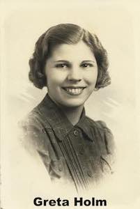 Greta Holm in a studio photo, looking at the camera and smiling