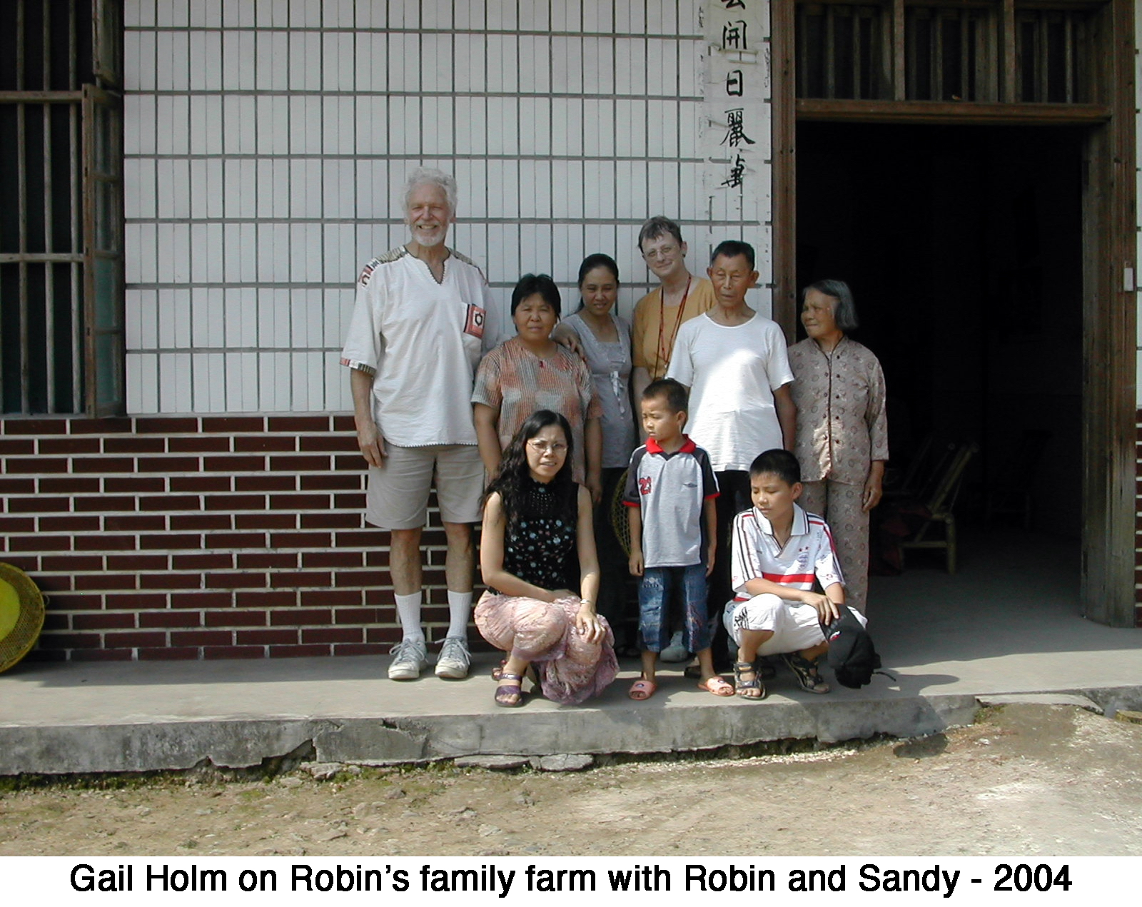 Gail with others in front of the Chinese farmhouse 