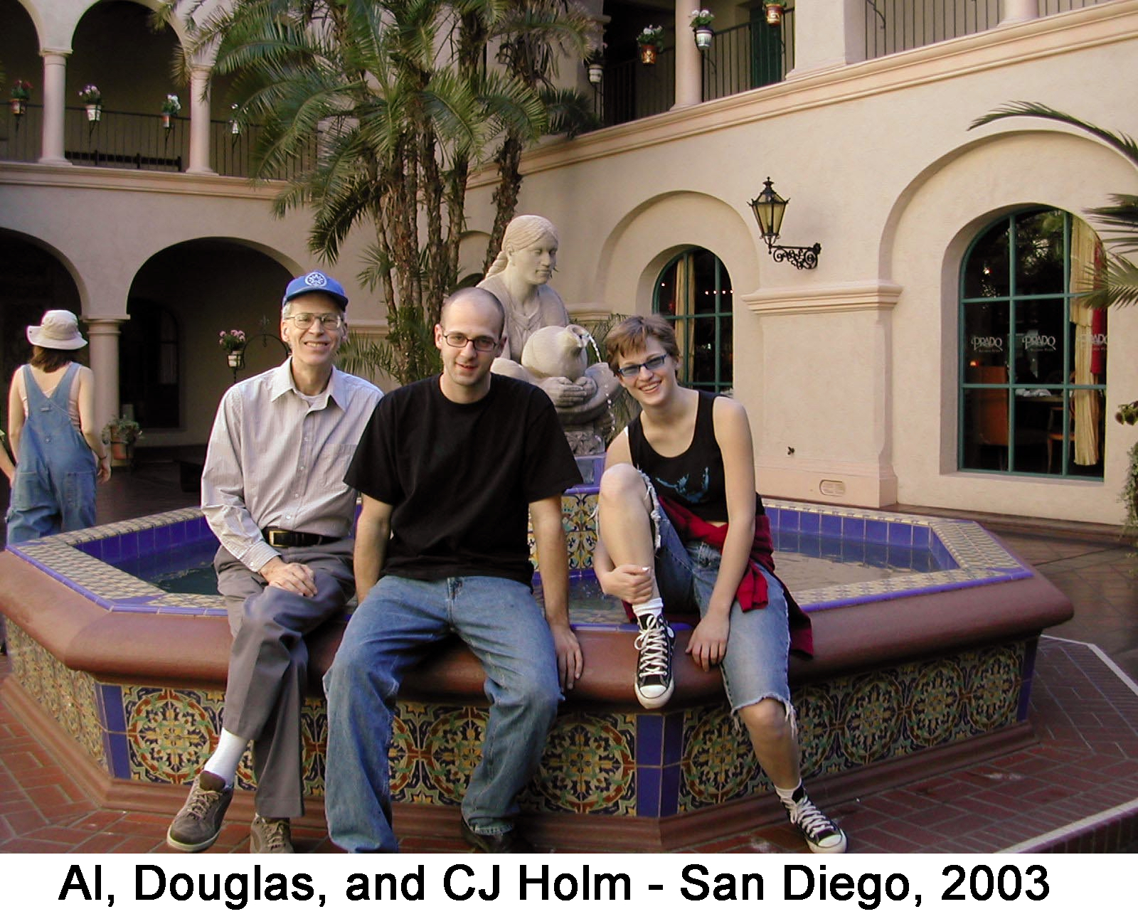 Al, Douglas, and CJ Holm sitting on a fountain at Balboa Park in San Diego.