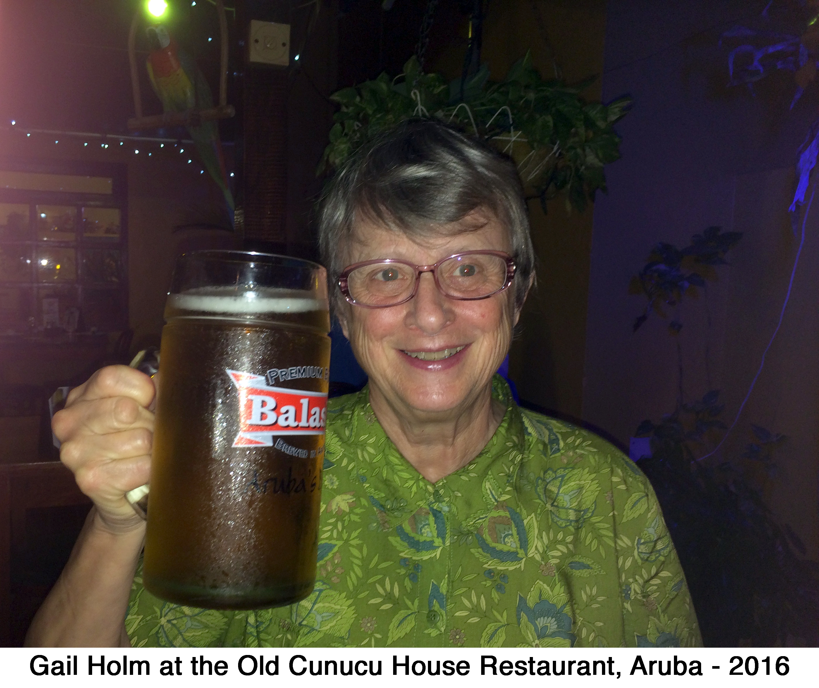 Gail Holm smiling and holding a huge mug of beer