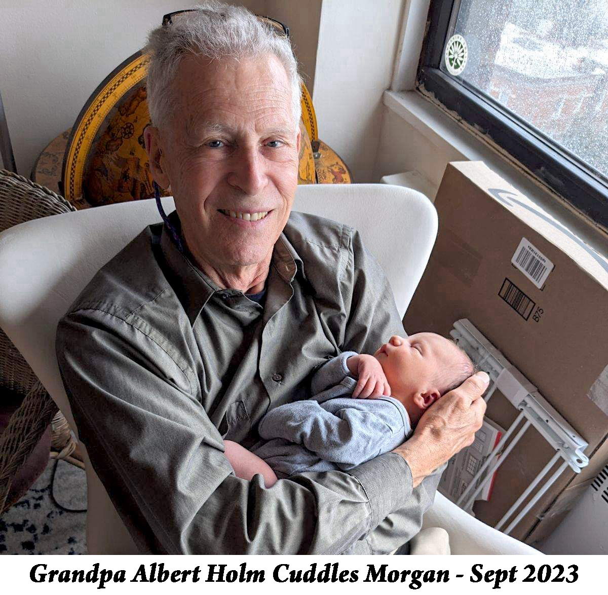 Grandpa Albertt Holm cuddles Morgan by the apartment’s window