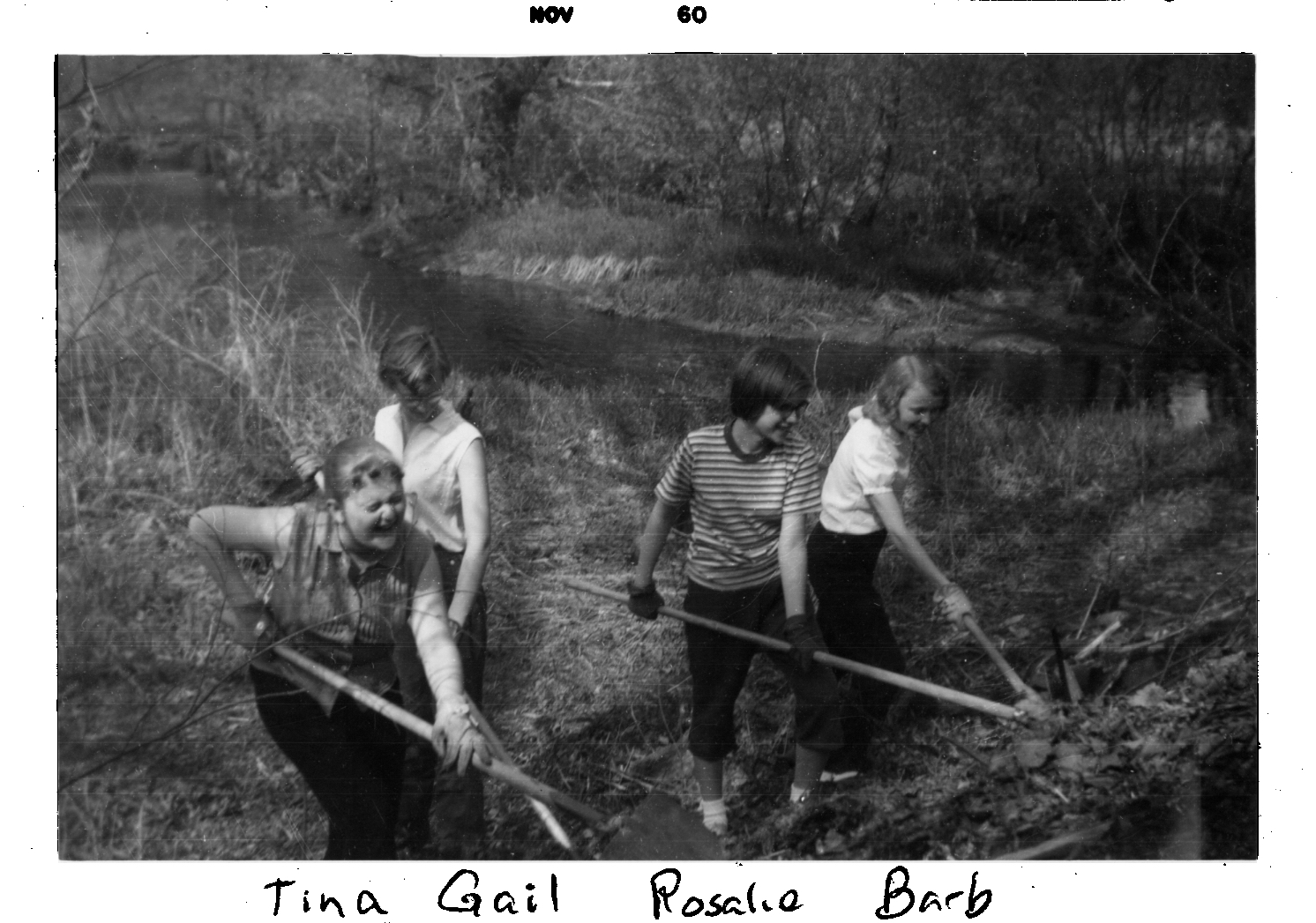 Gail Paton and three friends with rakes and shovels are cleaning the 
              bank of the stream behind them