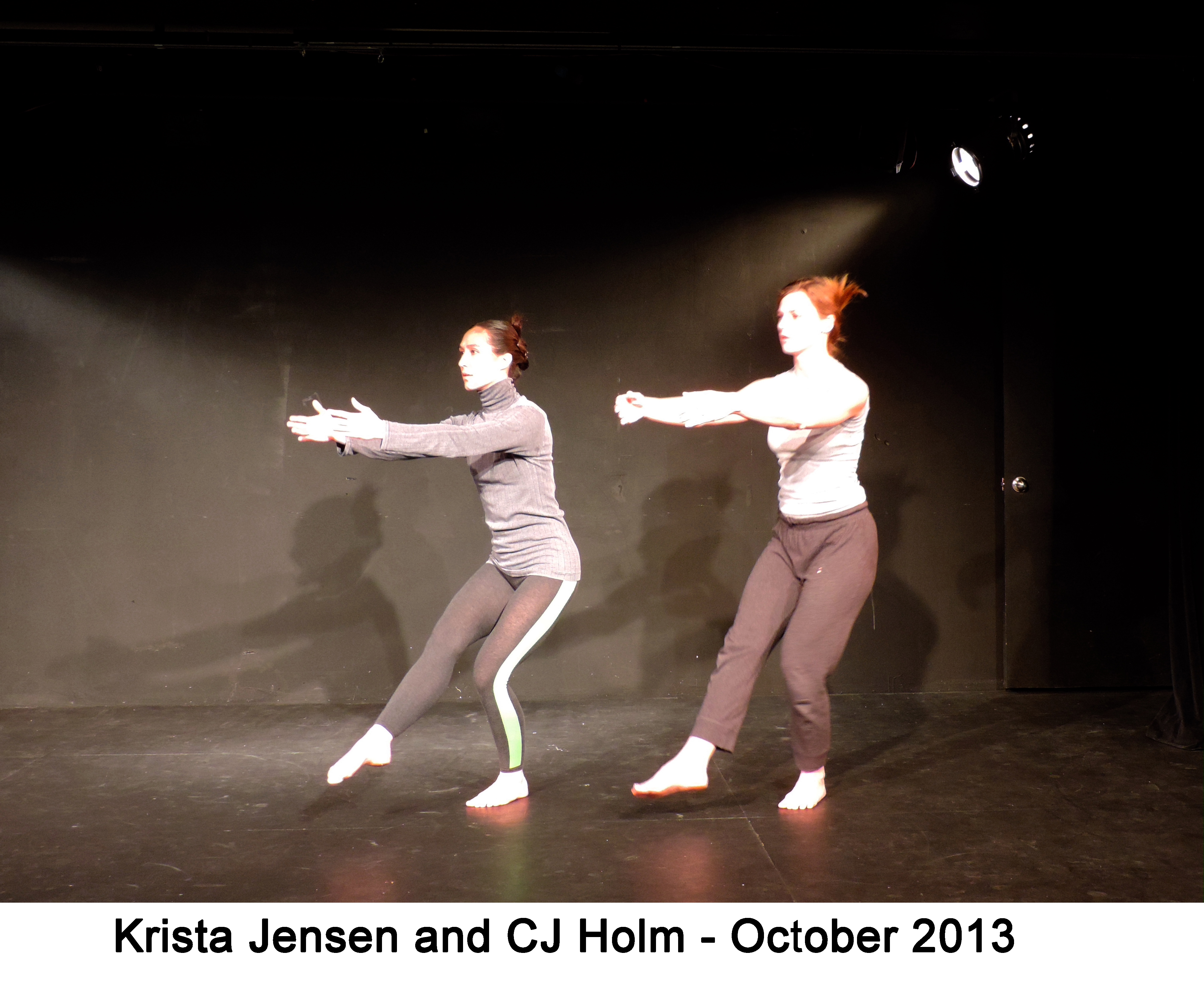 Krista and CJ are performing a movement with their arms and one leg outstretched