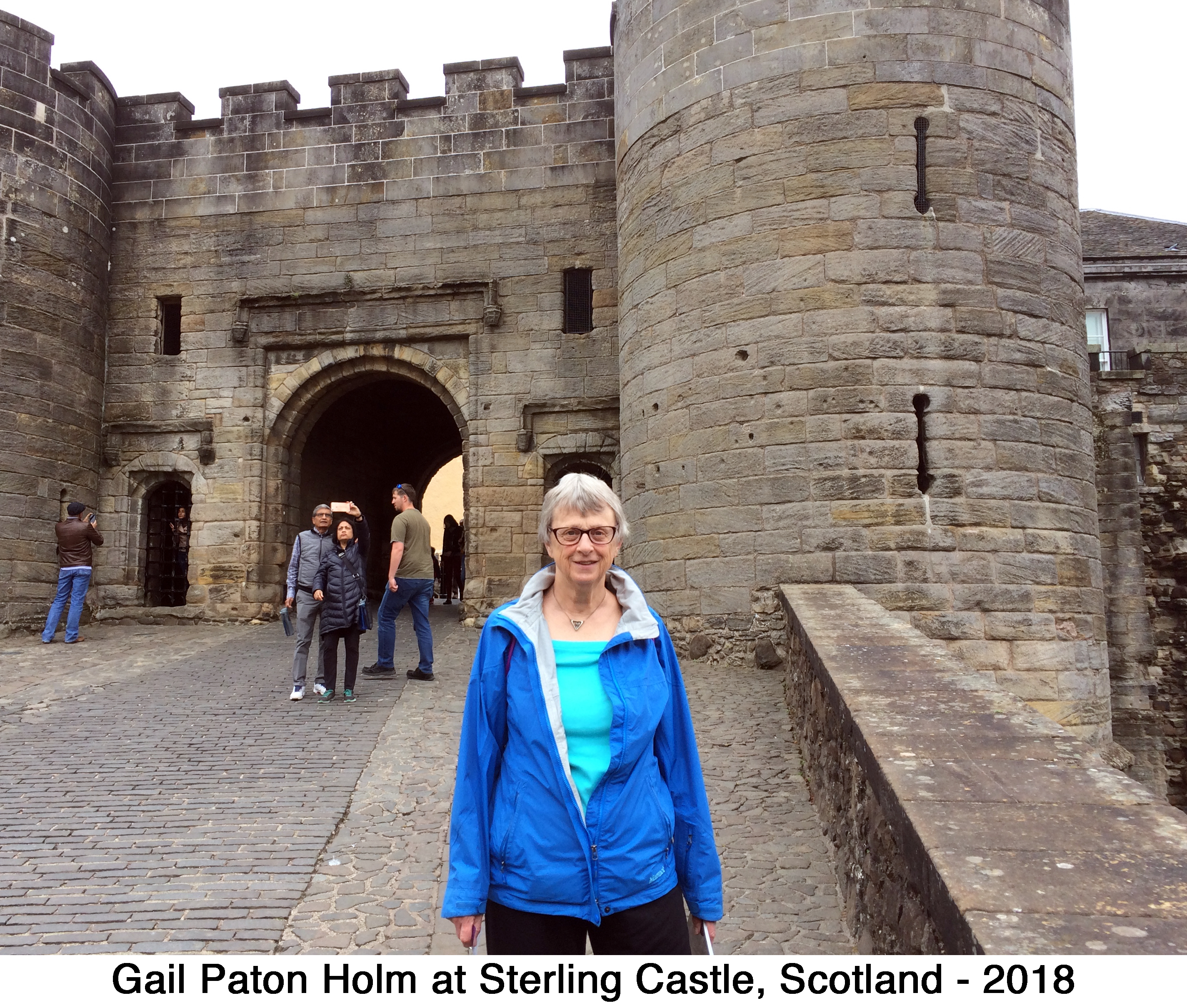 Gail Holm standing at the gate to Sterling Castle, Scotland