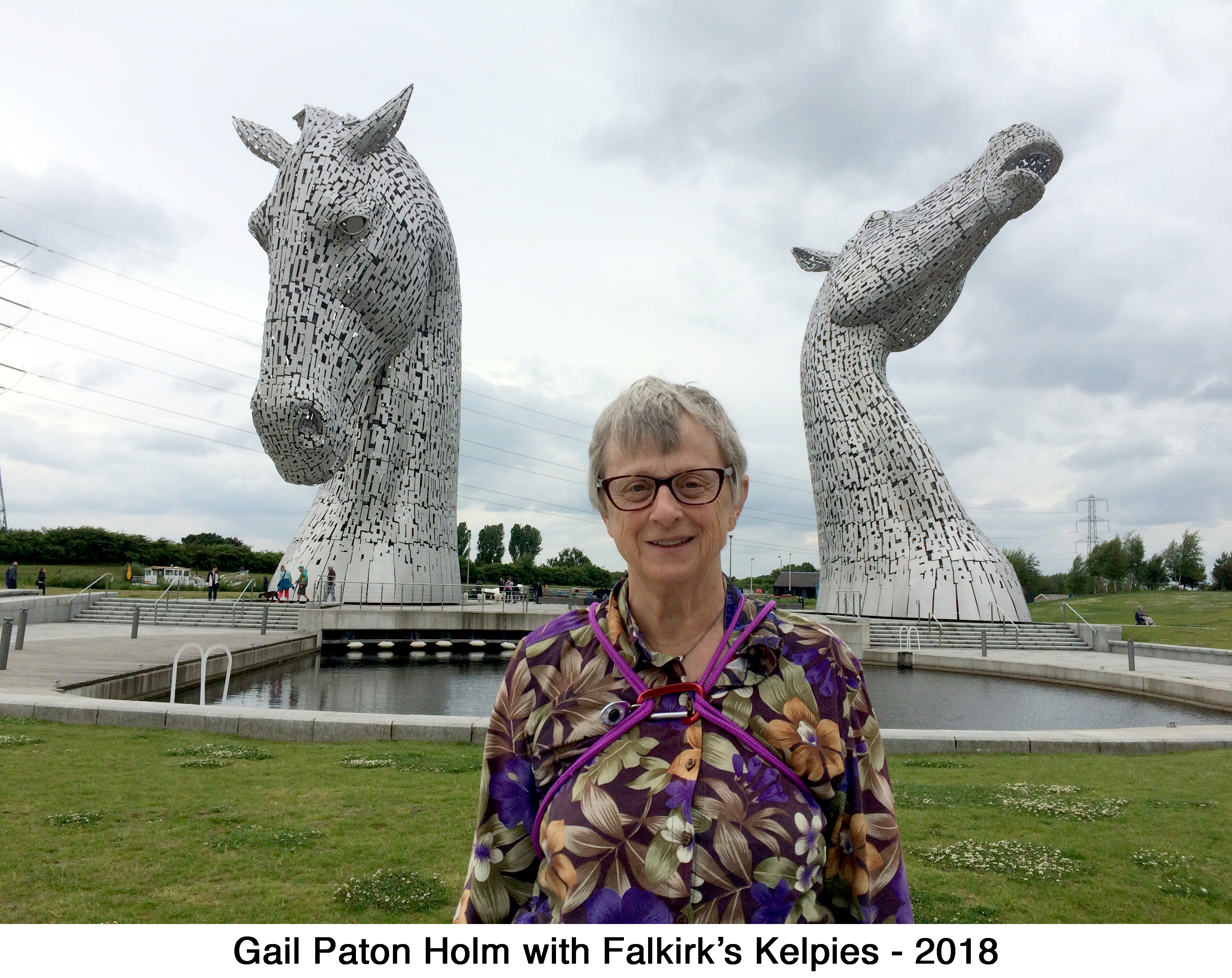 Gail Holm in front of the large horse head sculptures in Falkirk, Scotland