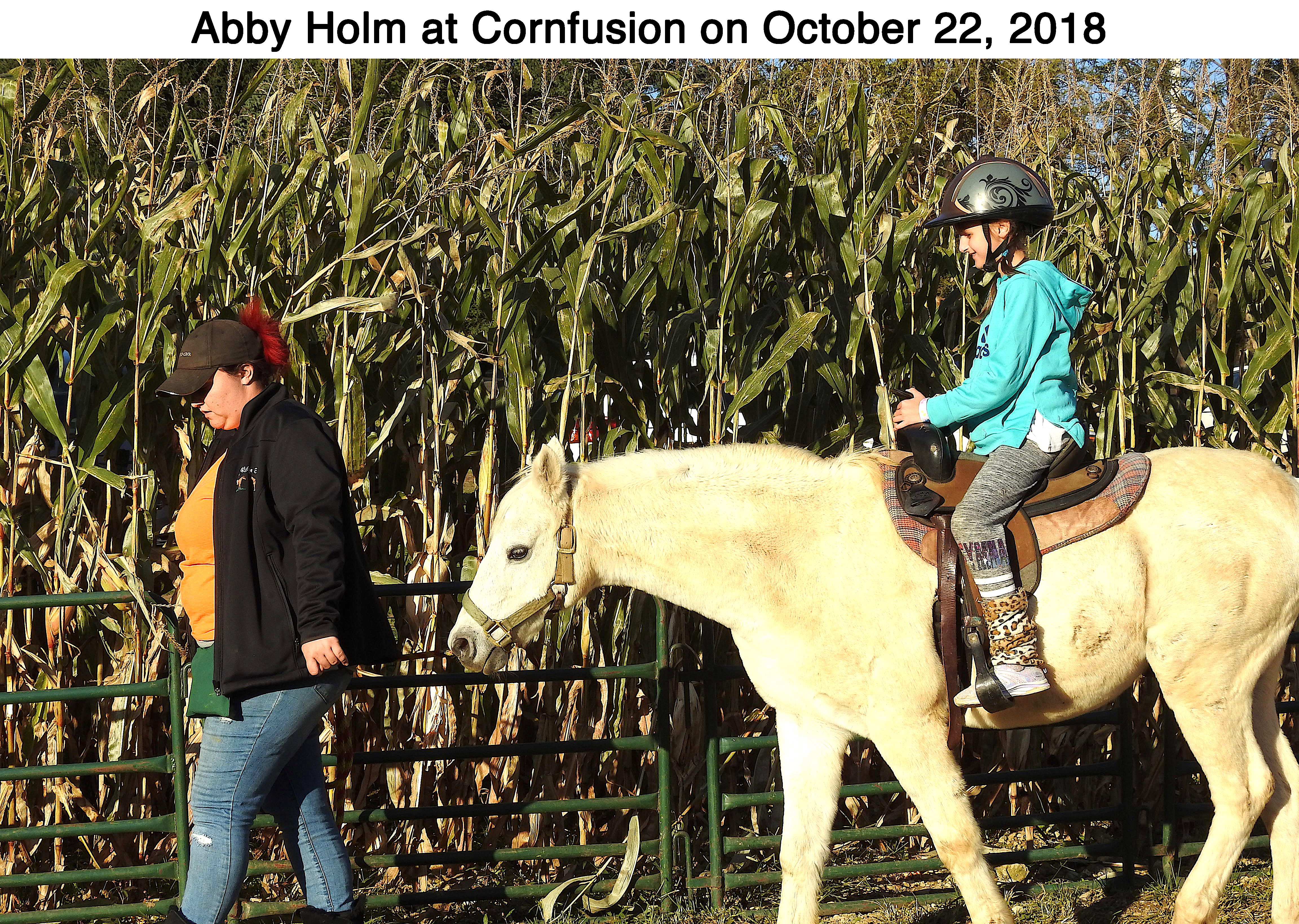 Abigail Holm riding on a horse at a corn maze