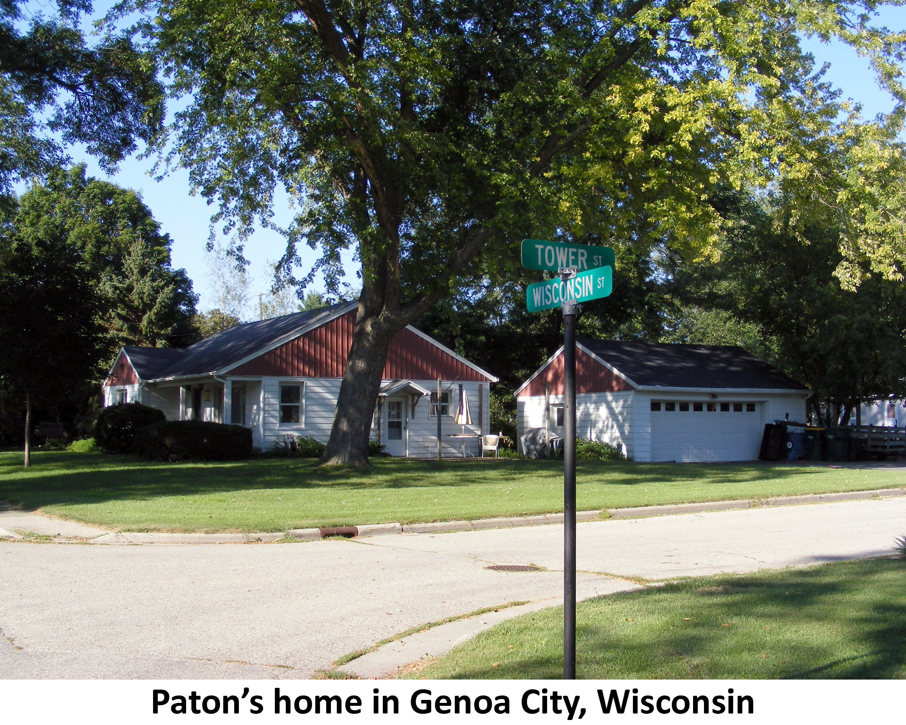 The one-story house and two-car garage are sitting under
          a shade tree on the corner of Wisconsin and Tower Streets.