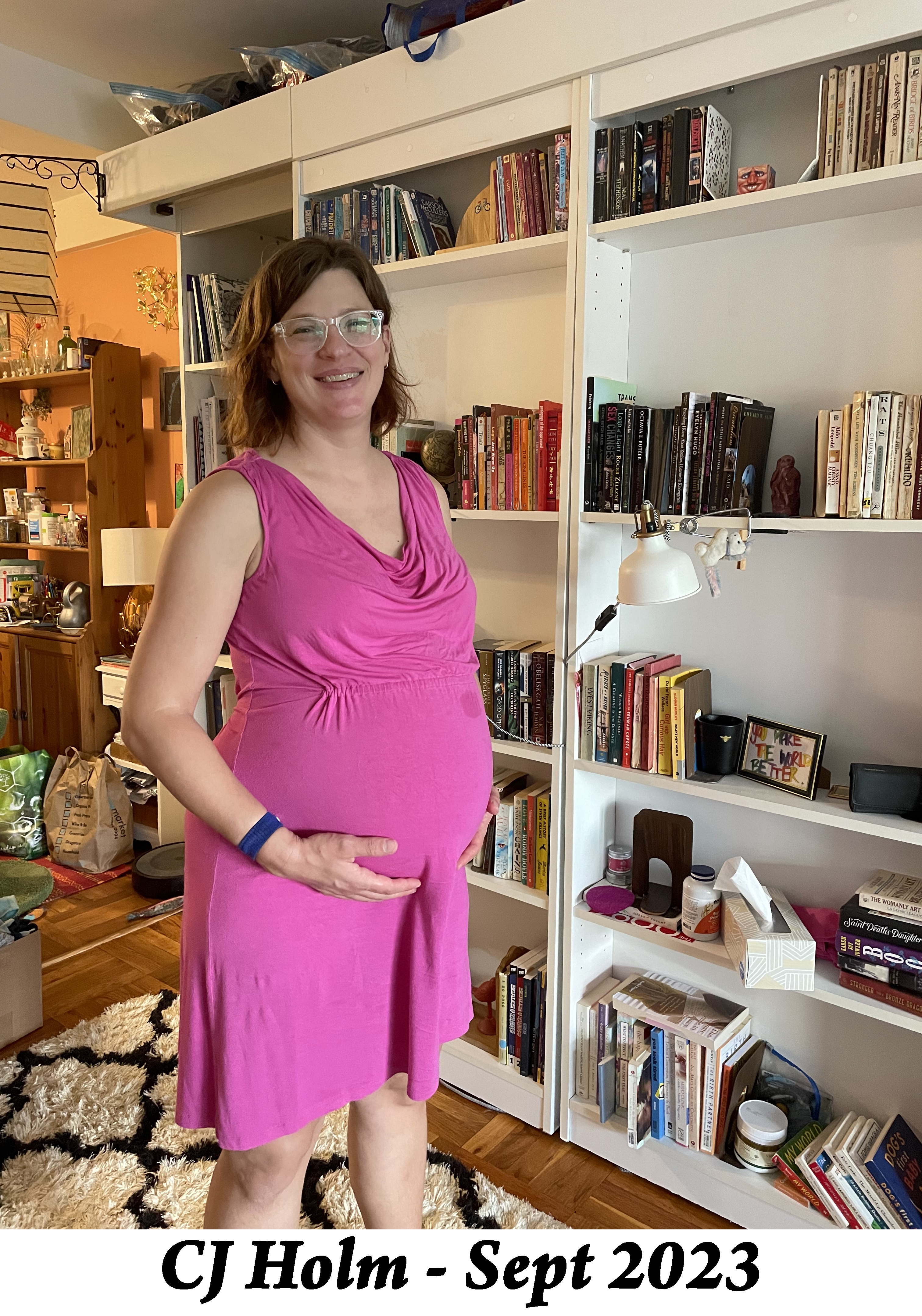 CJ stands beside her Murphy bed in her apartment