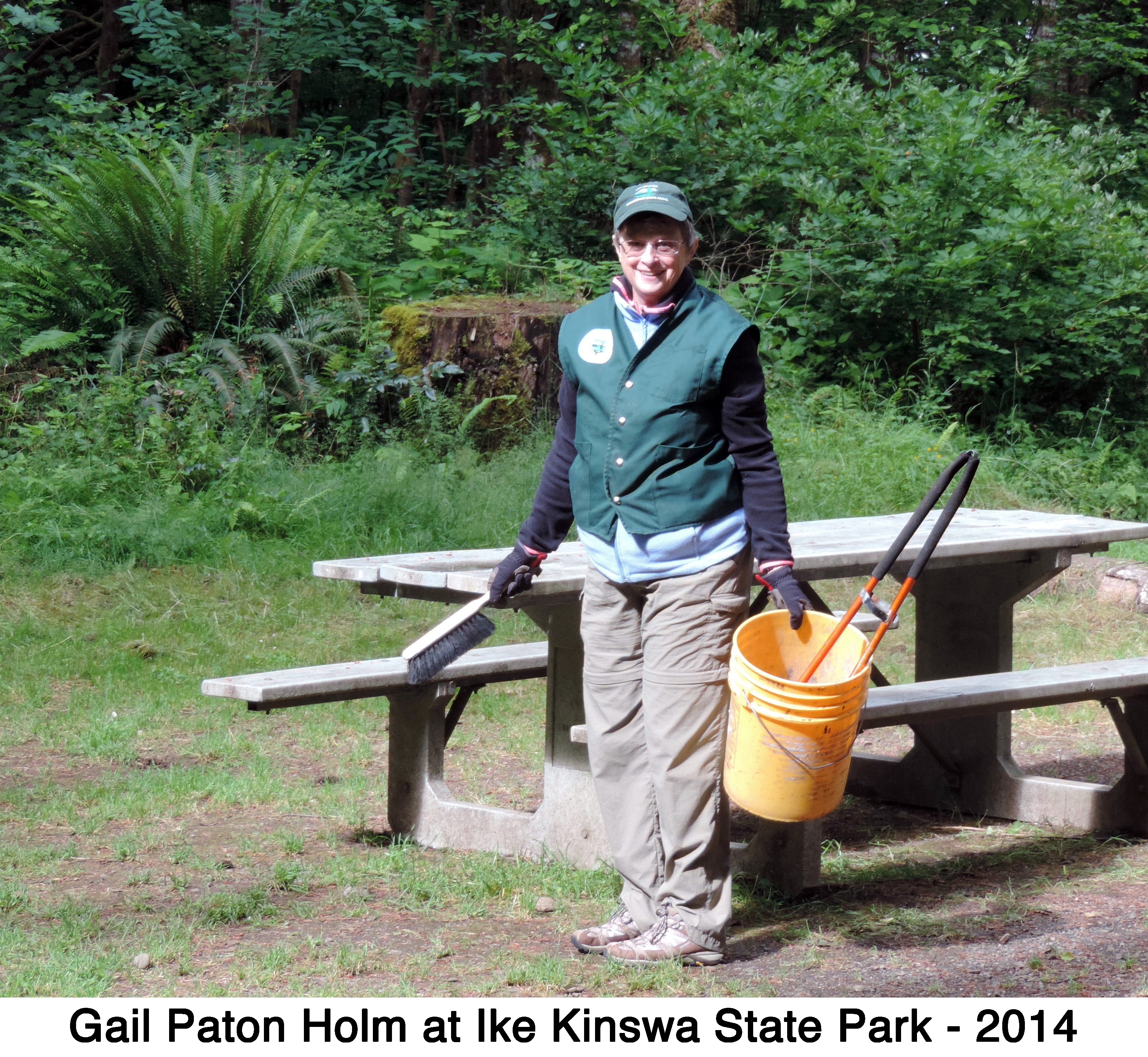 Gail Holm with cleaning tools at a picnic table