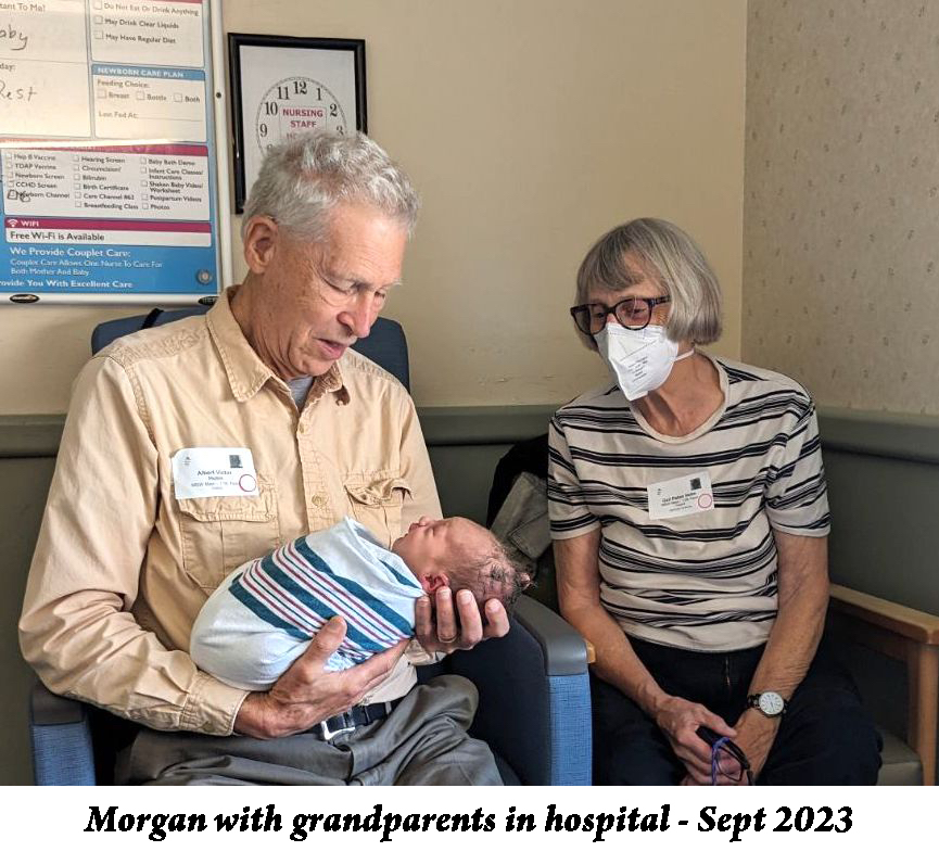 In the hospital room, Albert Holm is holding Morgan while Gail looks on