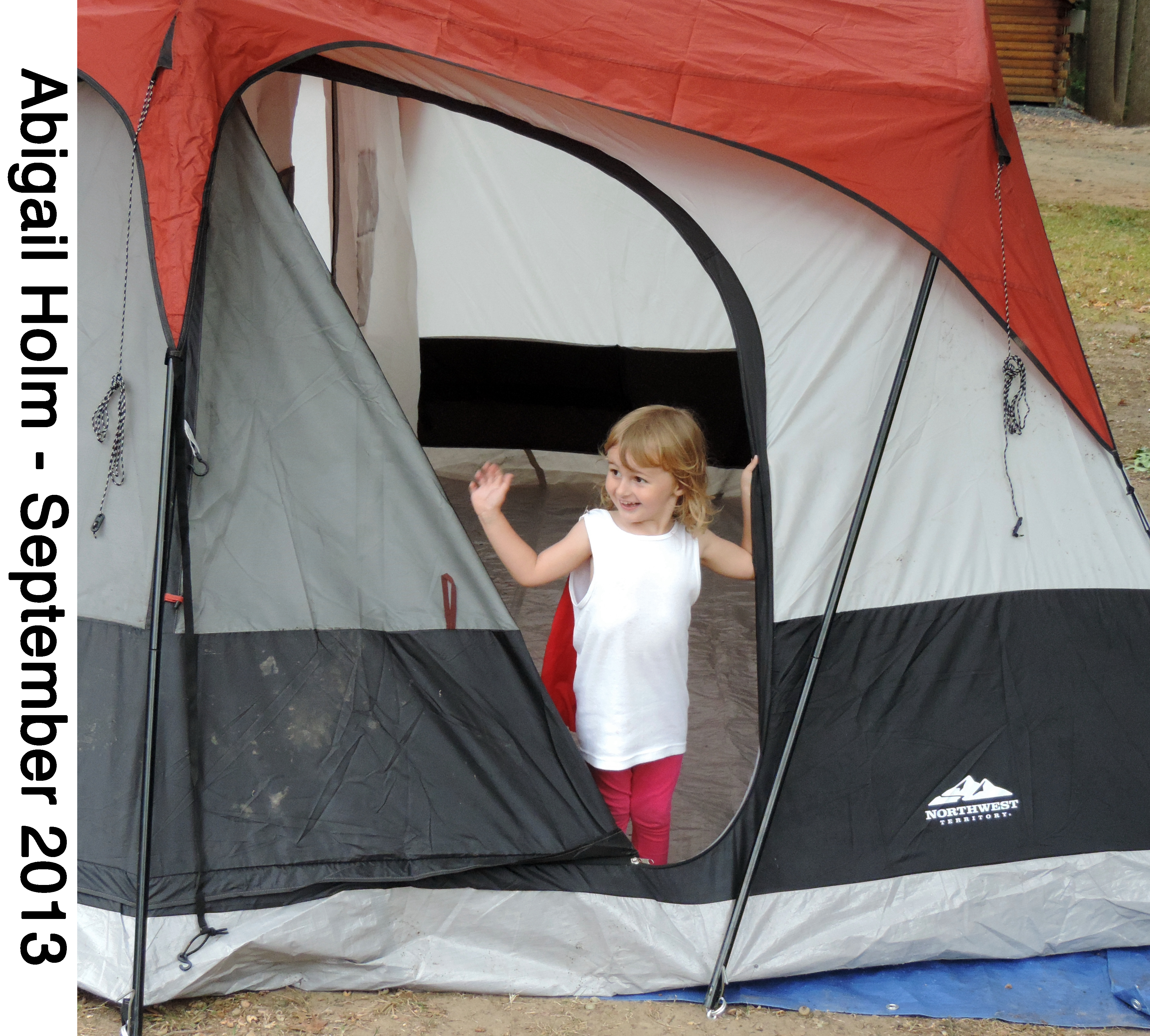 Abigail Holm waves from the door of her family’s tent