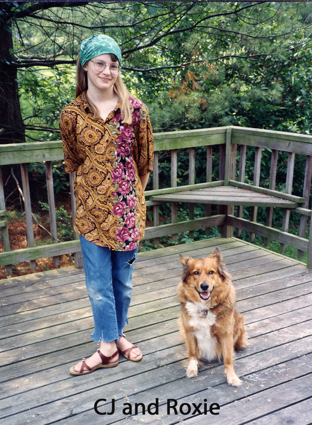 CJ is wearing hippie clothes and Roxie sits patiently looking at the camera