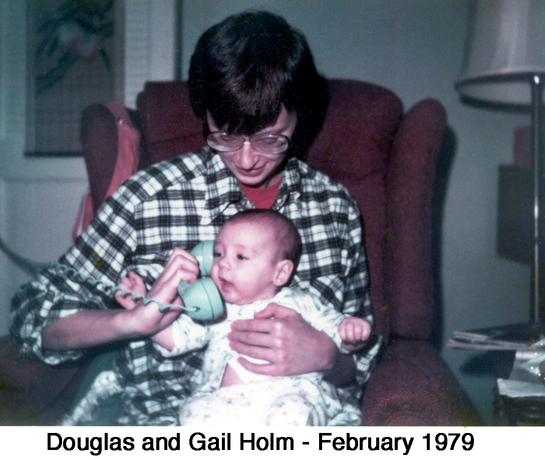 3-month-old Doug sitting in Gail’s lap and listening to the phone