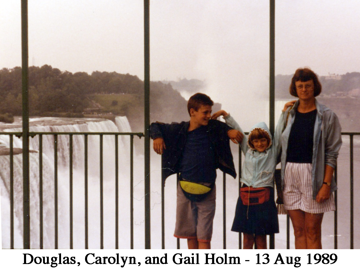 Douglas, Carolyn, and Gail standing by the railing with the falls in the background