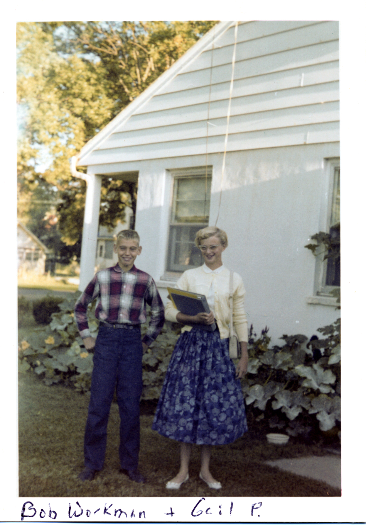 Bob Workman and Gail Paton standing in front of her home