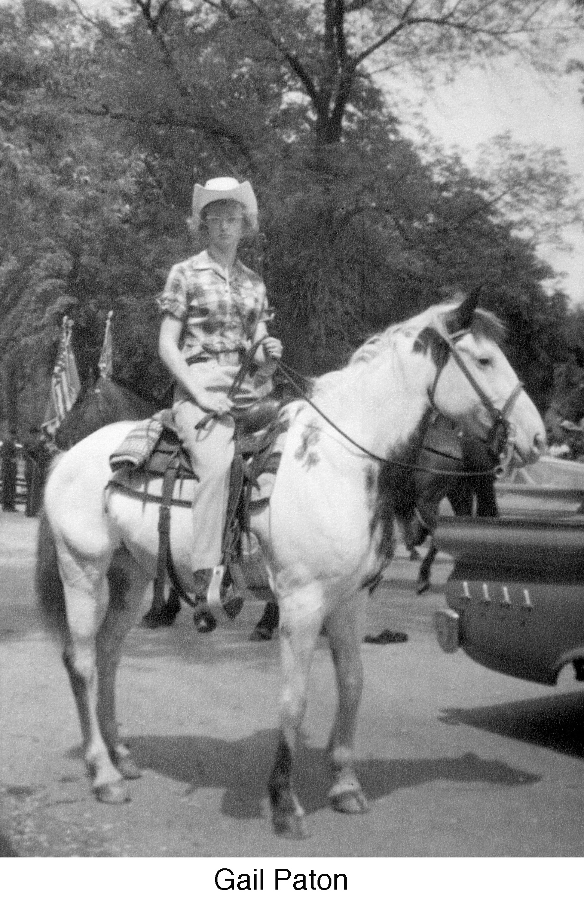 Gail riding a horse in a parade